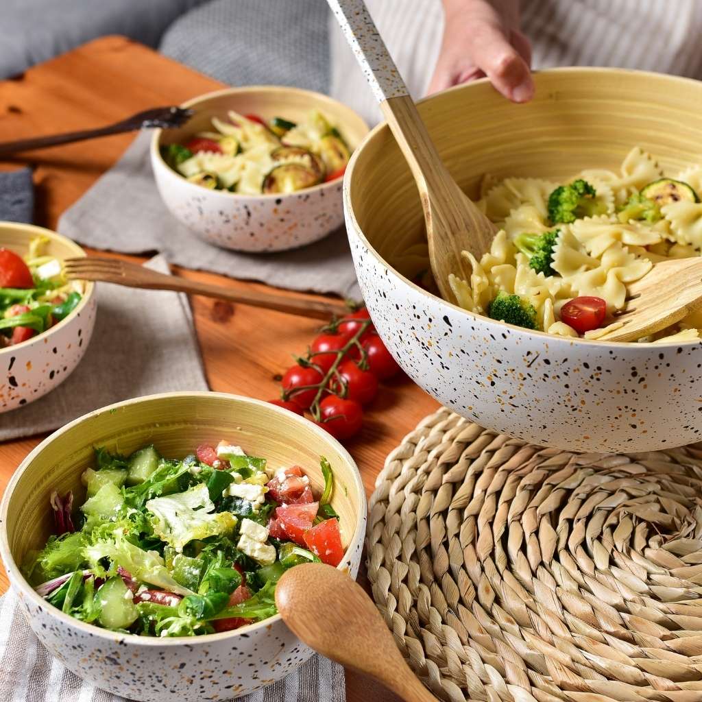 bamboo salad tongs in wood bowl